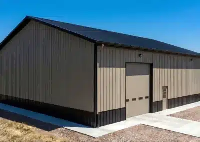 Steel pole barn warehouse with loading dock in Ontario under clear sky
