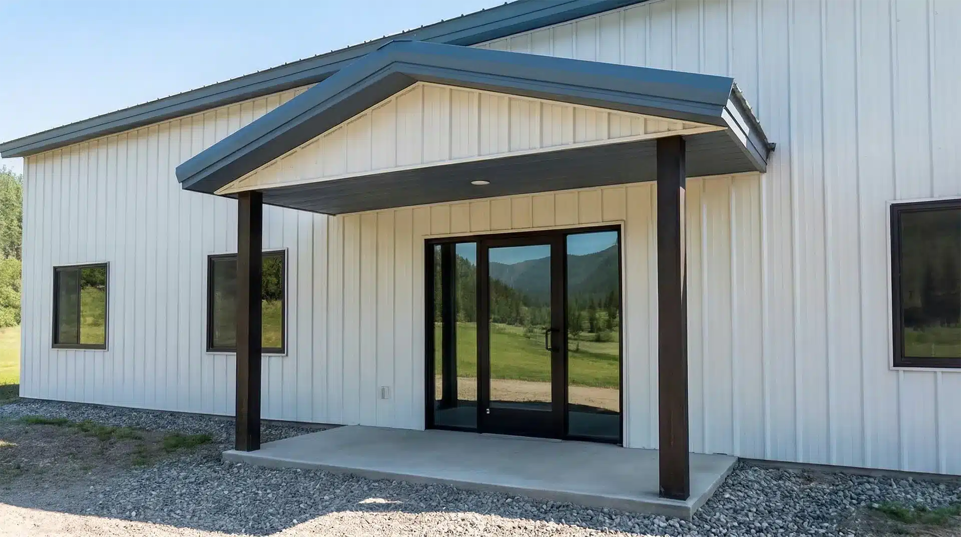 Covered lean-to porch on a steel pole barn in winter.