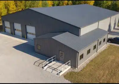 Custom agricultural steel building with post frame and wainscoting.
