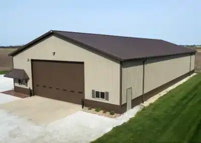 Large steel pole barn with big doors for farm implement storage