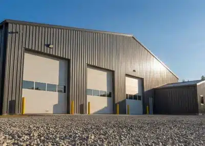 Large steel drive shed with overhead doors for farm machinery storage