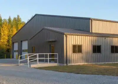 Insulated steel farm workshop with office bump-out in rural Canada.