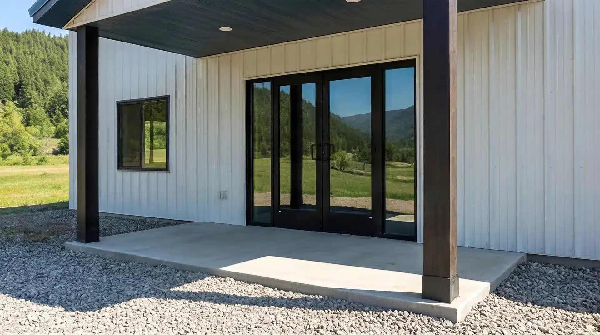 Insulated metal pole barn workshop with a man door entrance