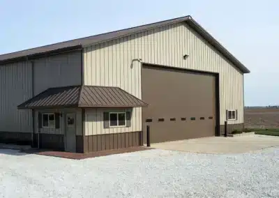Large metal roof post frame building in a rural setting