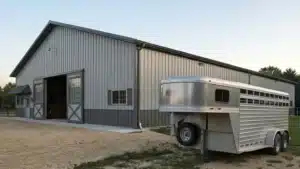 Metal horse arena with trailer in Ottawa, Ontario, showcasing steel barn design.