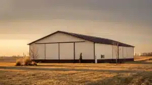 Large steel farm storage building in a field at sunset, Markham, Ontario.