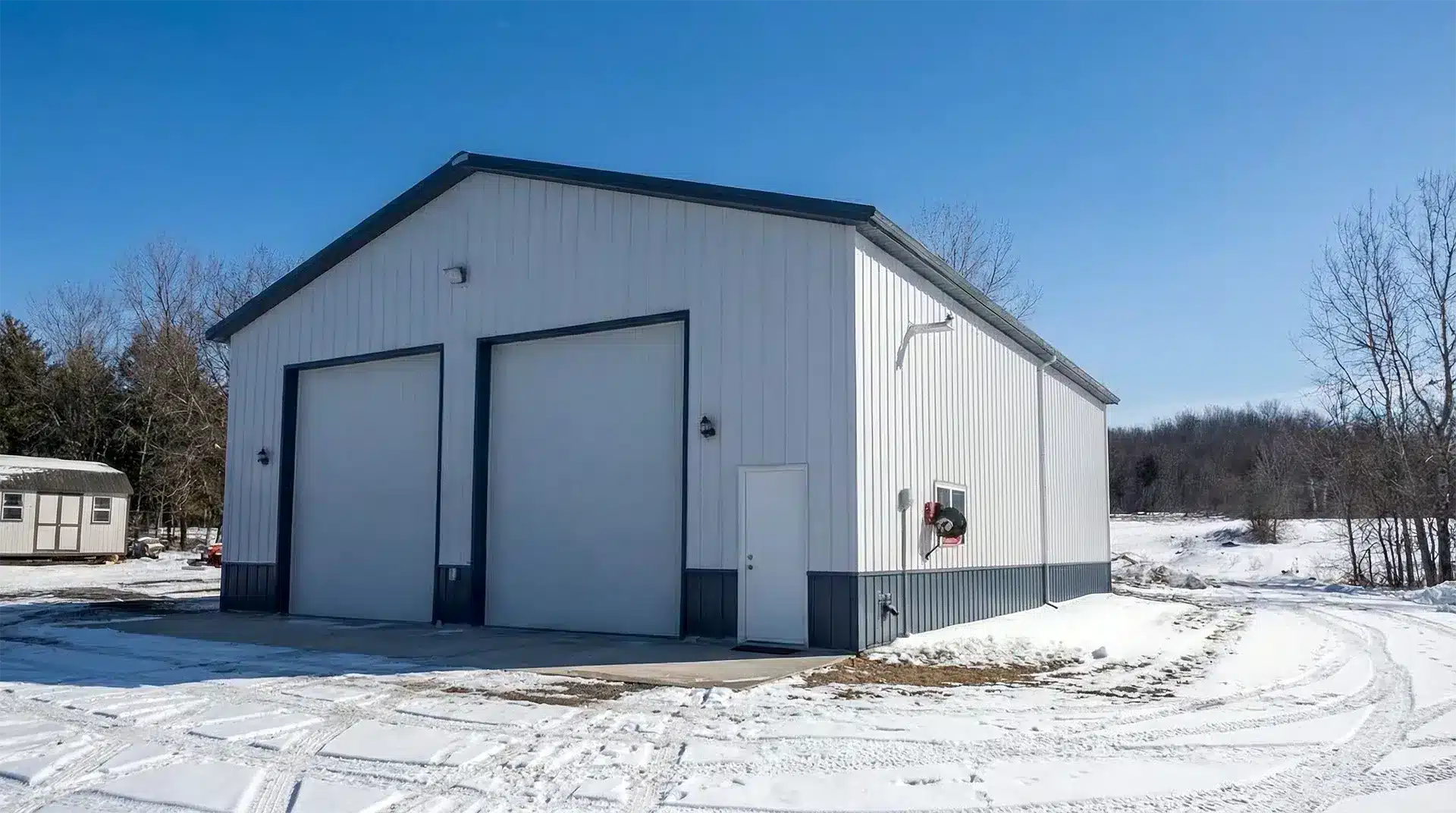 24x30 Steel Garage Kawartha Lakes 24x30 steel garage in Kawartha Lakes with front left corner view in winter.