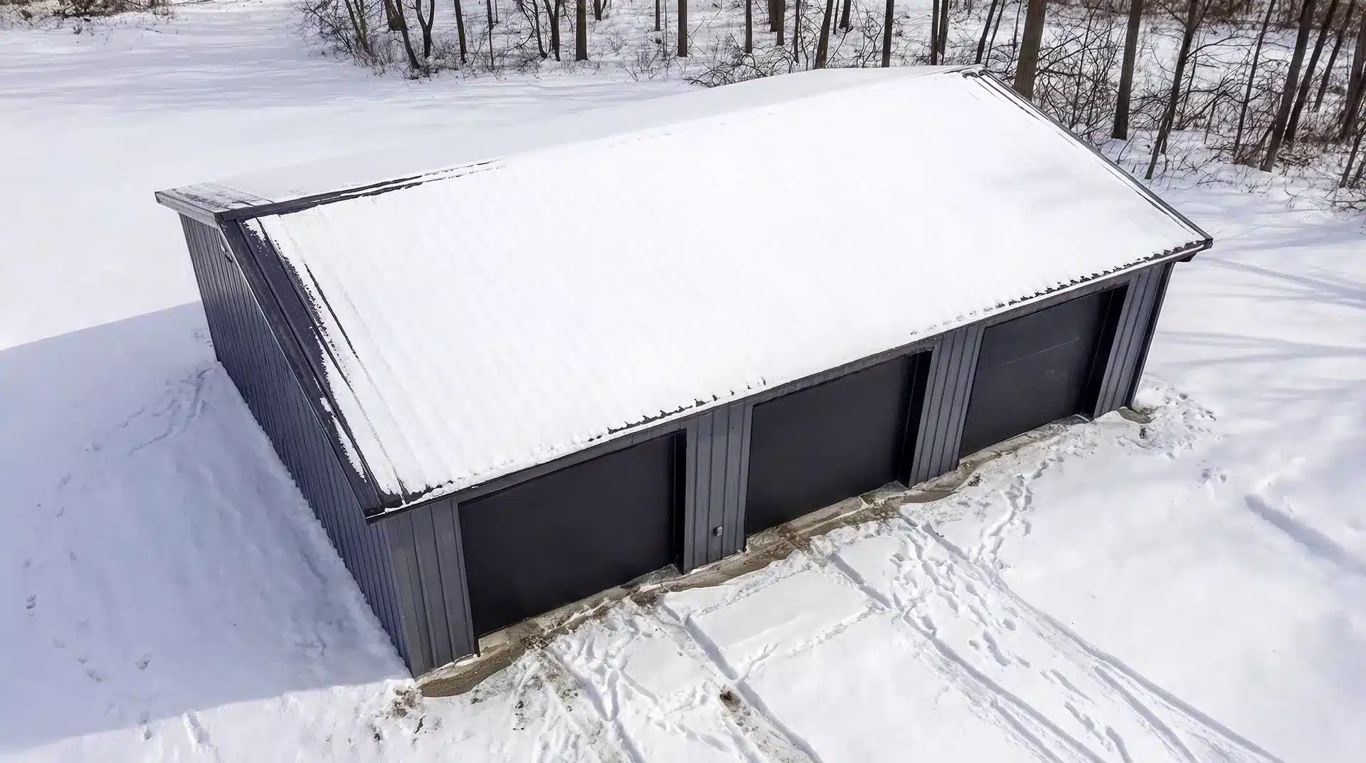 24x36 Triple Car Garage Workshop Newmarket Aerial Front View Aerial front view of a snow-covered 24x36 steel triple car garage in Newmarket.