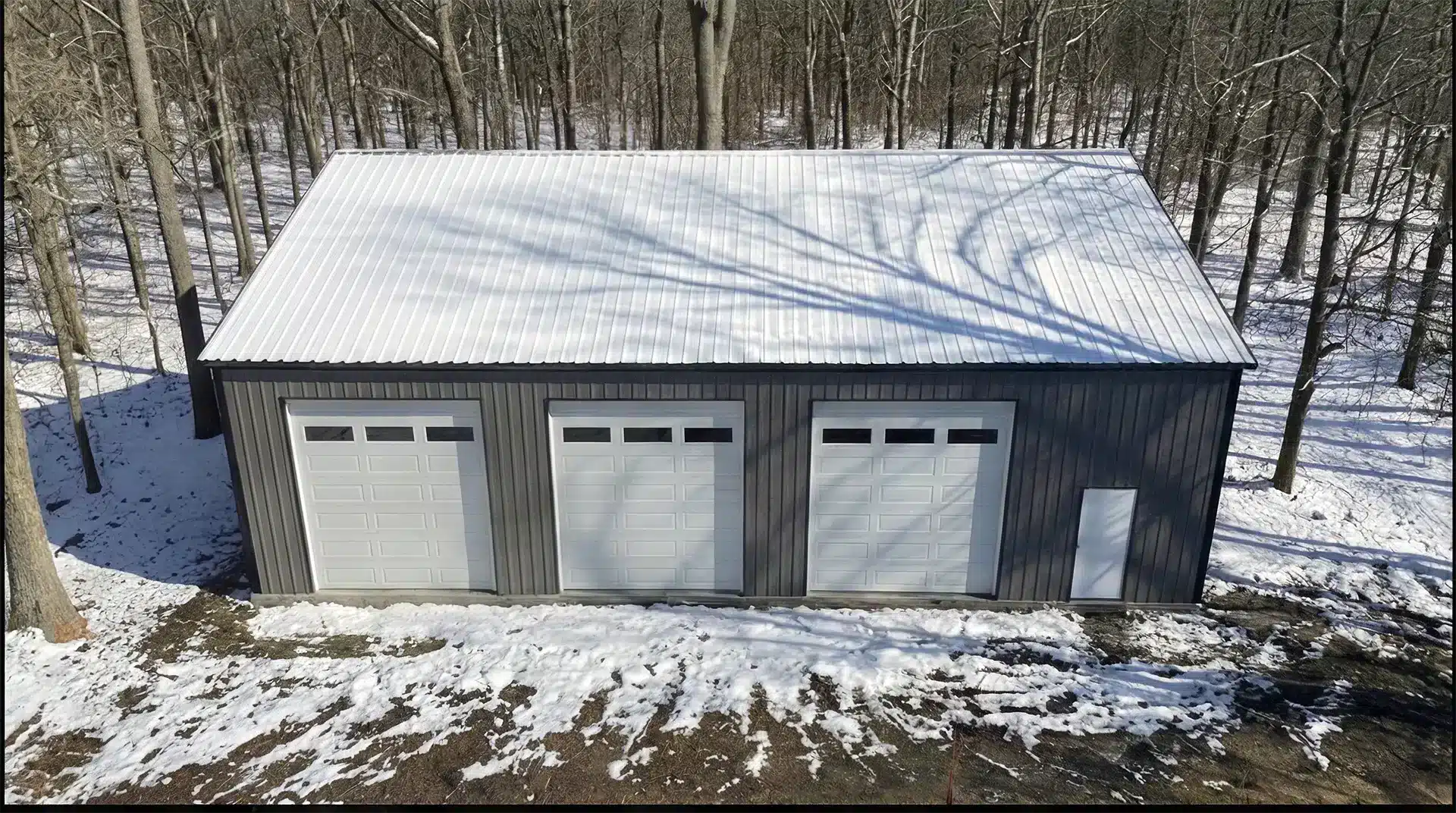 30x50 Insulated Workshop Kit North Bay Aerial view of a 30x50 insulated steel workshop with three doors in snowy North Bay.