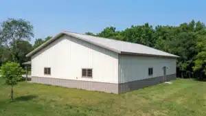 Rear view of 60x42 steel barn in Peterborough, Ontario with trees in the background.