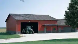 Red metal farm shop exterior with open door and tractor in Waterloo, Ontario.