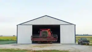 Steel barn with front entry containing a large agricultural vehicle in Windsor, Ontario.