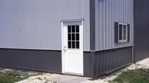 Detail of a metal barn with service door in Sudbury, Ontario.